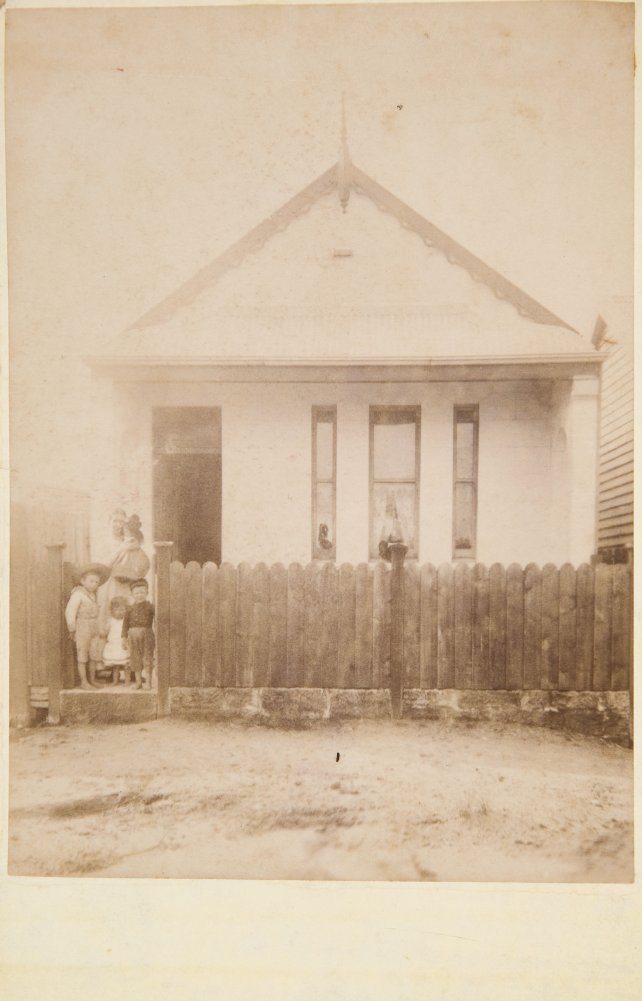 Woman and children outside an unidentified stone cottage, probably in Newtown, Sydney, ca.1889 / Austral Photo Company