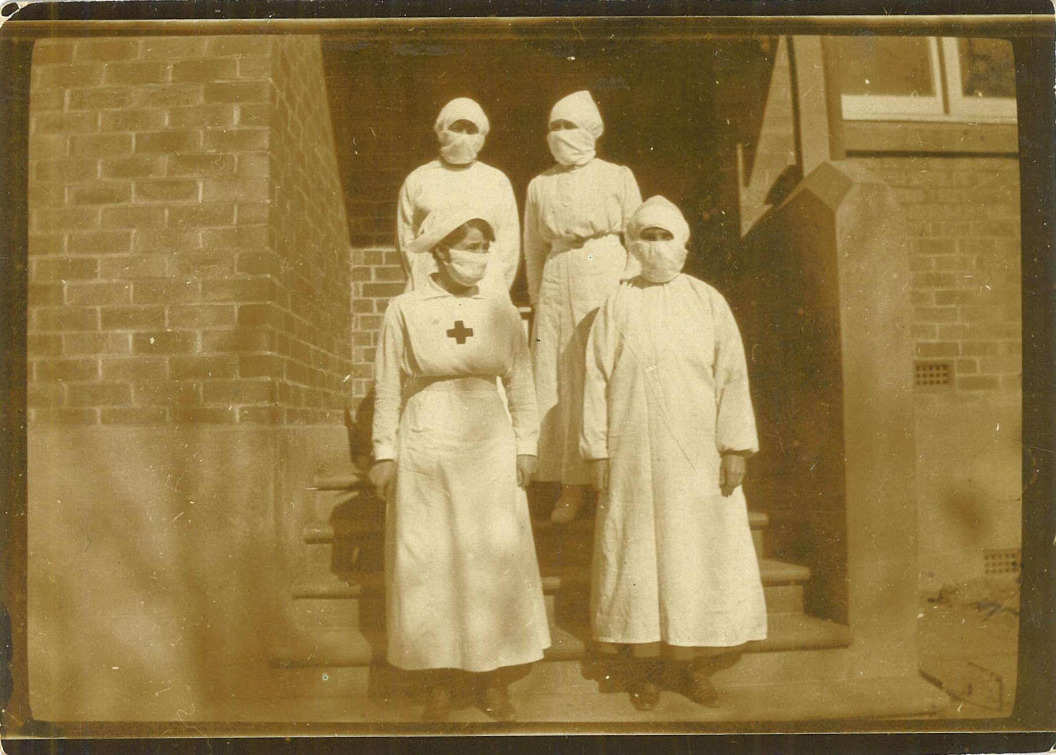 Helen Macgregor and fellow nurses outside the Nowra Public School converted into a temporary hospital for pnemonic influenza epidemic, 1919 / photographer unknown