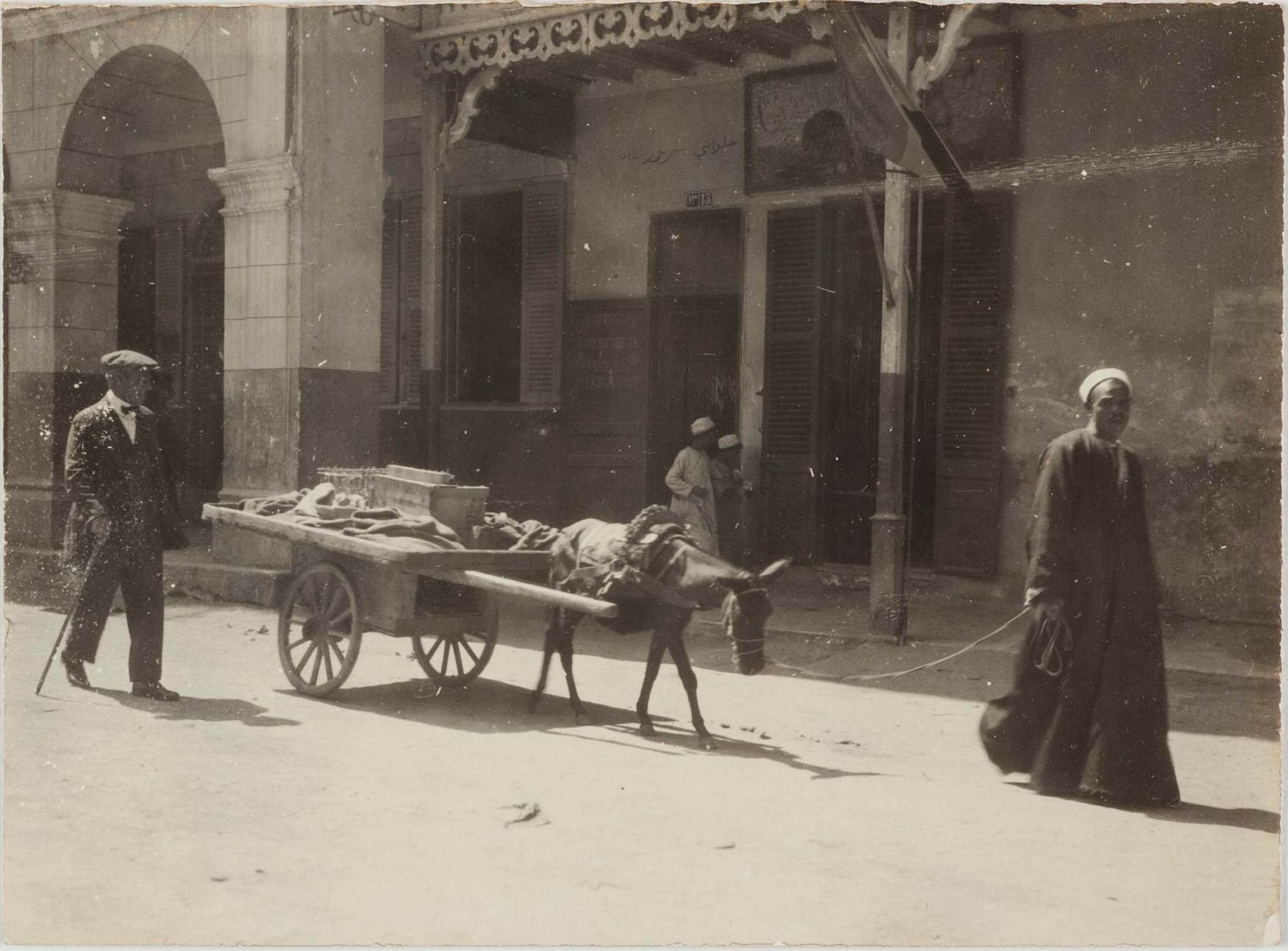 Port Said, Egypt, 18 April 1919: Dora and Leslie Walford with officers from RMS Osterley. Ephtimios Brothers Stores, 'Oriental curiosities' in the background / photographer unknown