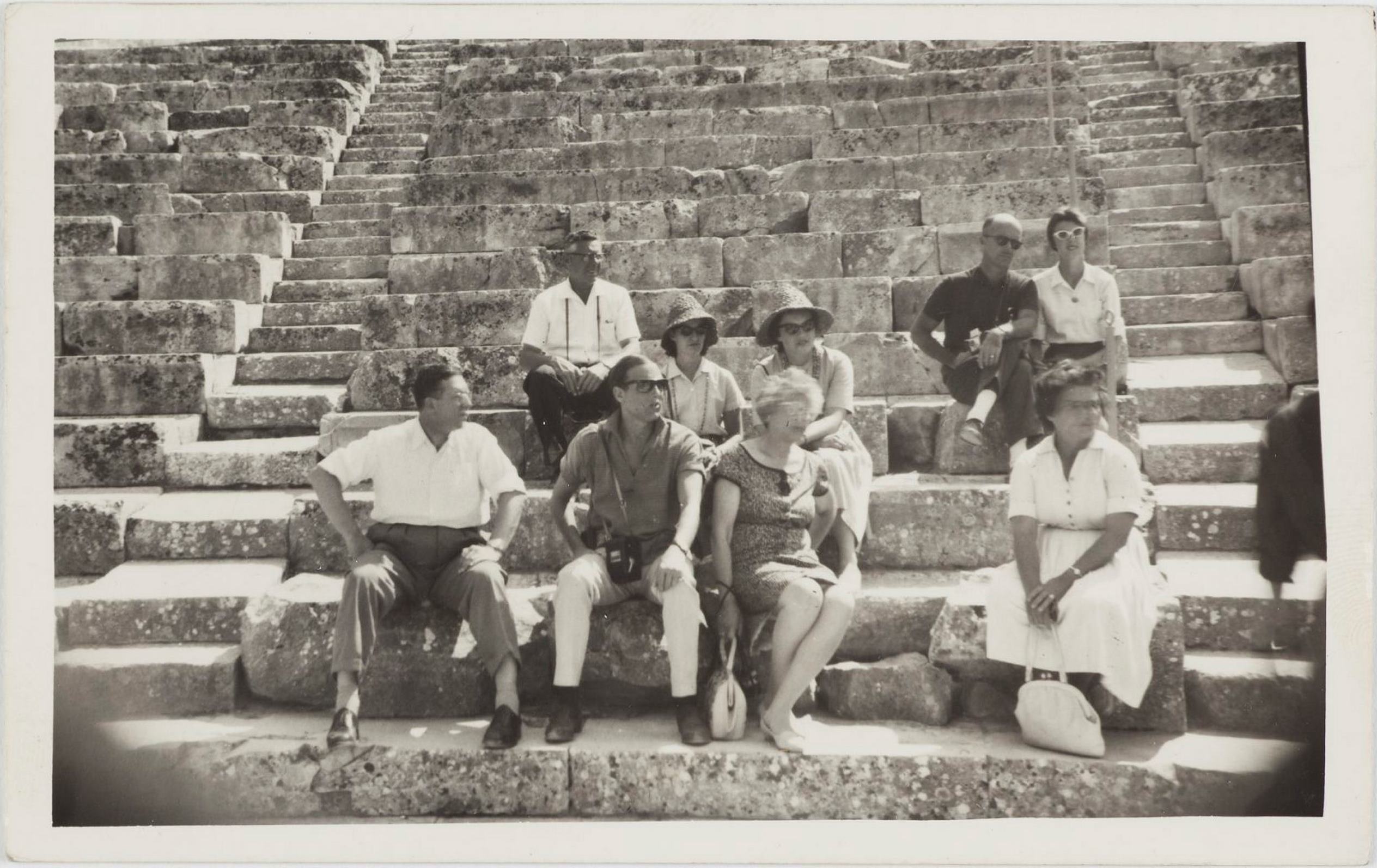 Leslie Walford and fellow tourists in an anceint amphitheatre, probably Epidaurus, Greece, July 1961 / photographer unknown