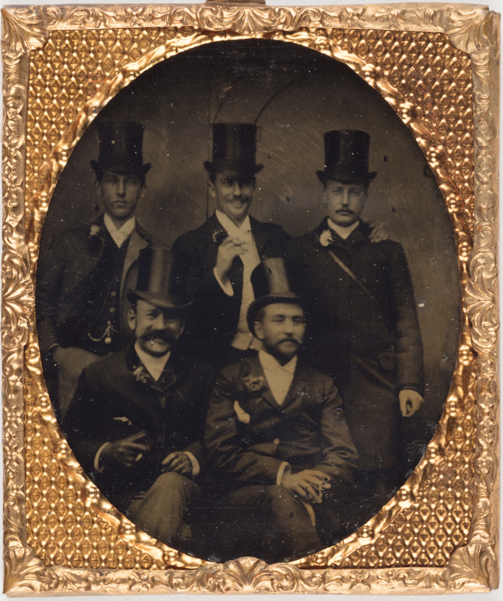 Tintype photograph of group of five men wearing formal dress, including Leslie Walford (1869-1928), around 1885  / photographer unknown